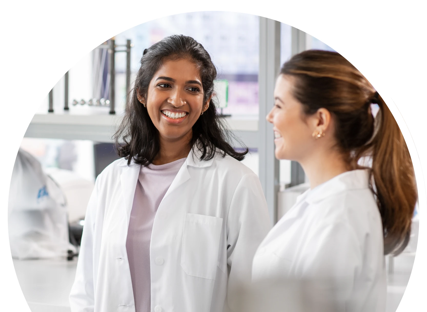 Women in lab coat talking