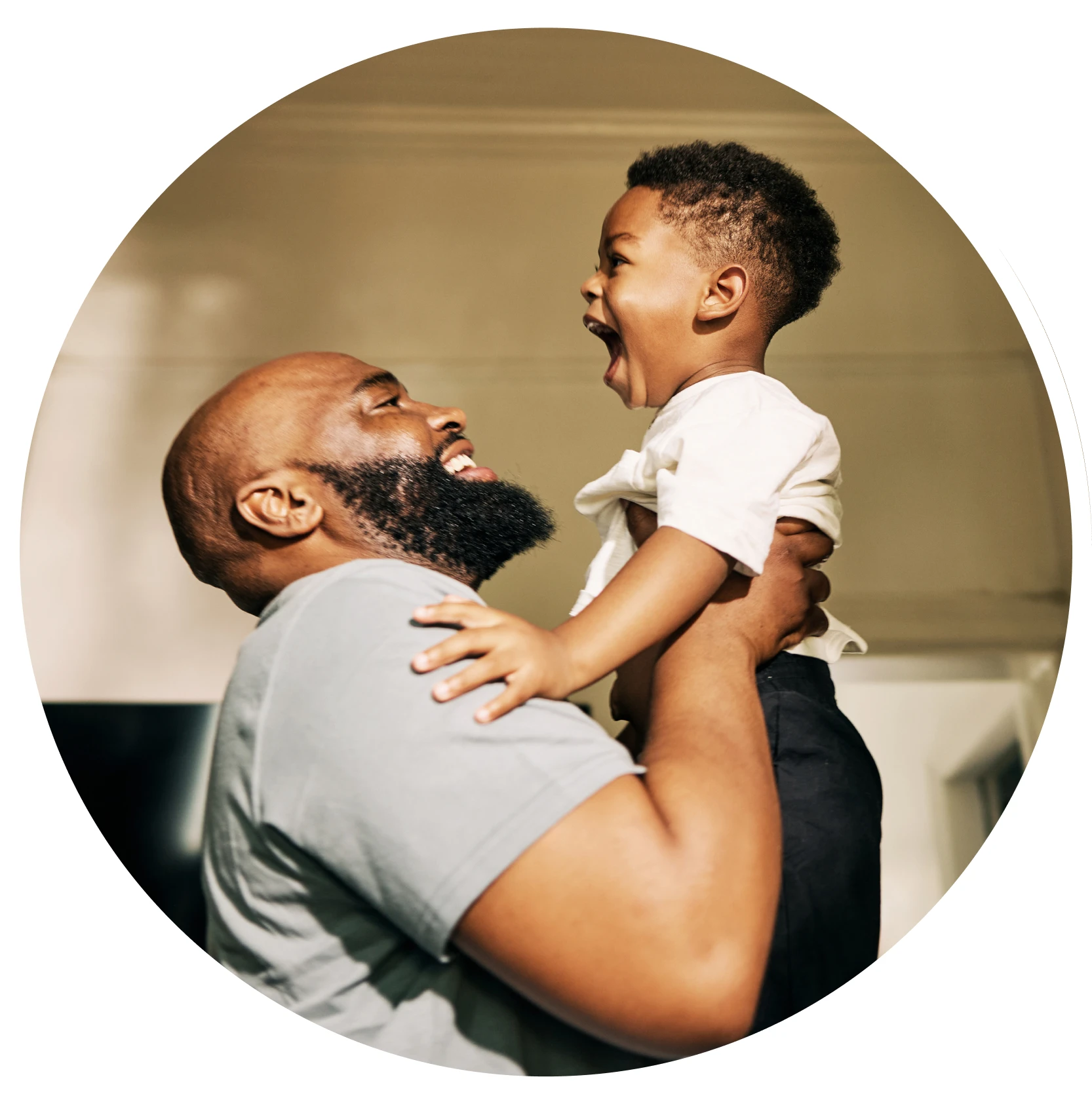 Smiling parent holding up happy child